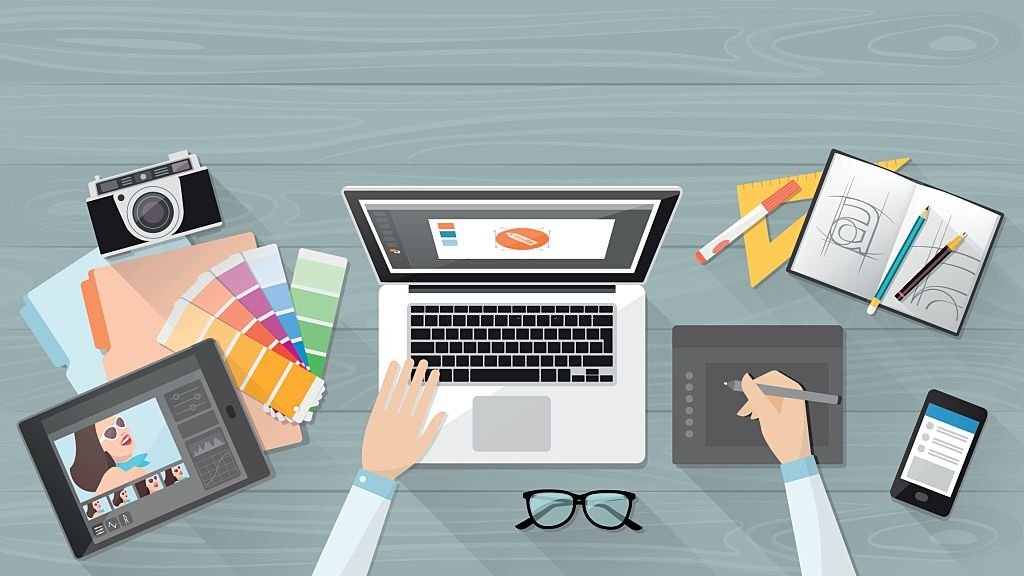 Graphic Design Tips: 10 Proven Ways To Improve Projects 3 Graphic Designer At A Desk Applying Graphic Design Tips To A Layout