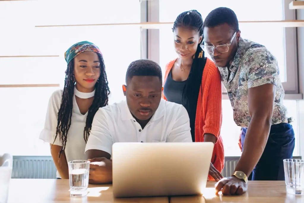 Web Designer In Takoradi: 7 Proven Reasons To Hire Local 3 Local Team Collaborating With A Client, A Web Designer In Takoradi At Work